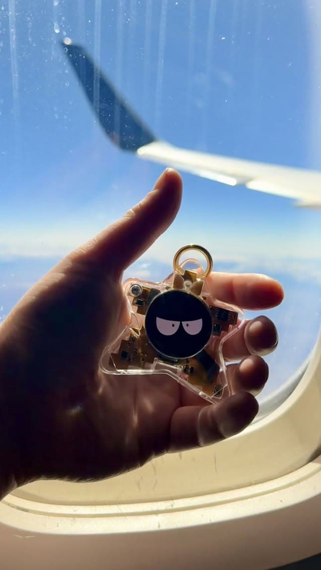 Real Oneira product held in front of an airplane window